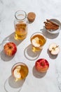 Fresh red apples and apple juice in glasses and bottle on a light background. Fruits and drinks. Top view, copy space.