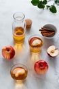 Fresh red apples and apple juice in glasses and bottle on a light background. Fruits and drinks. Top view, copy space.