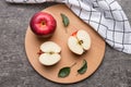 Fresh red apples with green leaves on table. cutting board with knife. Top view