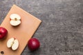 Fresh red apples with green leaves on table. cutting board with knife. Top view