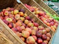 Fresh red apples on the market counter. Apples in a wicker box on a grocery shelf. Close-up of fruit in a supermarket Royalty Free Stock Photo