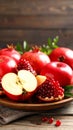 Fresh red apples and pomegranates on wooden plate with rustic background Royalty Free Stock Photo