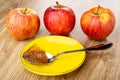 Fresh red apples, spoon with apple marmalade in saucer on wooden table