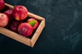 Fresh red apples in a wooden box. Organic food. On a white wooden background. Royalty Free Stock Photo