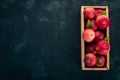 Fresh red apples in a wooden box. Organic food. On a black background. Royalty Free Stock Photo