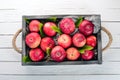 Fresh red apples in a wooden box. Organic food. On a white wooden background. Royalty Free Stock Photo