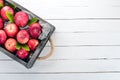 Fresh red apples in a wooden box. Organic food. On a white wooden background. Royalty Free Stock Photo