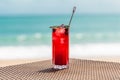 Fresh Red Berries Cocktail on Beach Table, Defocused Turquoise Sea on Background Royalty Free Stock Photo