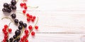 Fresh red and black currant on a white wooden background Top view Royalty Free Stock Photo