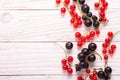 Fresh red and black currant on a white wooden background Top view Royalty Free Stock Photo