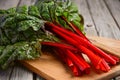 Fresh red chard leaves on wooden background