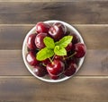 Fresh red cherries. Cherries in a bowl. Background of berries. Ripe cherry on wooden background. Royalty Free Stock Photo