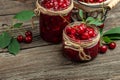 Fresh red cherries fruit on wooden background. Jar of cherry jam and sour cherries. Berries cherry with syrup. Canned fruit. place Royalty Free Stock Photo