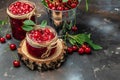 Fresh red cherries fruit on wooden background. Jar of cherry jam and sour cherries. Berries cherry with syrup. Canned fruit. place Royalty Free Stock Photo