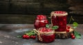 Fresh red cherries fruit on wooden background. Jar of cherry jam and sour cherries. Berries cherry with syrup. Canned fruit. place Royalty Free Stock Photo