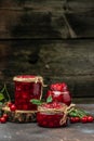 Fresh red cherries fruit on wooden background. Jar of cherry jam and sour cherries. Berries cherry with syrup. Canned fruit. place Royalty Free Stock Photo