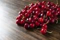 Fresh red cherries on wooden table. Summer harvest. Delicious berries. Close up.
