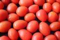 Fresh red cherry tomatoes on a black background. Good for presentation background and recipe content.