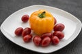 Red cherry tomatoes and yellow bell peppers close up Royalty Free Stock Photo