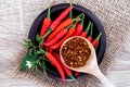 A fresh red chilli pepper and crushed dried red cayenne pepper with seeds , rich of antioxidant herbal food Royalty Free Stock Photo