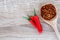 A fresh red chilli pepper and crushed dried red cayenne pepper with seeds , rich of antioxidant herbal food Royalty Free Stock Photo