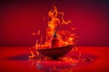 Fresh red chilli pepper in fire as a symbol of burning feeling of spicy food and spices. Red background. Neural network