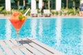 Fresh red cocktail with ice in glass on swimming pool. Tropical juice on luxury vacations. Concept summer holiday and Royalty Free Stock Photo