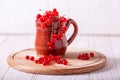 Fresh red currant in a ceramic cup on a white wooden background Royalty Free Stock Photo