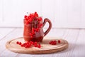 Fresh red currant in a ceramic cup on a white wooden background Royalty Free Stock Photo