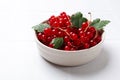 Fresh red currants and leaves in bowl on white table, closeup Royalty Free Stock Photo