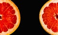 Fresh red grapefruit cut in half on black background Royalty Free Stock Photo