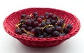 Fresh Red Grapes in a red basket isolated on white background Royalty Free Stock Photo
