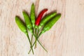Fresh red and green chilli on old wood background. guinea pepper