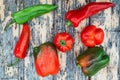 Fresh red green peppers on a wooden table