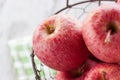 Fresh red juicy apples in a basket on a green textile on a wooden background Royalty Free Stock Photo