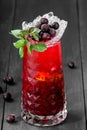 Fresh red lemonade with mint, black currant, lime and ice in glass on dark background. Royalty Free Stock Photo