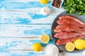 Fresh red mullet fish on blue wooden background with herbs Royalty Free Stock Photo