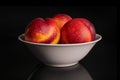 Fresh red nectarine isolated on black glass Royalty Free Stock Photo