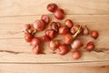Fresh red onion pile, fruits or vegetables herb isolated on wooden background closeup.