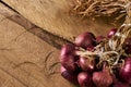 Fresh red onions on old rustic wooden table. Royalty Free Stock Photo