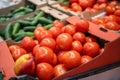 Fresh red organic tomatoes and other vegetables in farmers market or supermarket shelf, healthy food Royalty Free Stock Photo