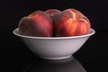 Fresh red peach isolated on black glass Royalty Free Stock Photo