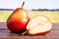 Fresh red pear with field behind