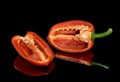 Fresh red pepper. Reflection on a black background