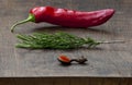 Fresh red pepper, sprig of rosemary, wooden spoon Royalty Free Stock Photo
