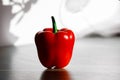 Fresh red pepper on a table with sun light from kitchen window