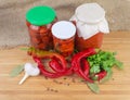 Fresh red peppers chili, pickled chili and other canned vegetables Royalty Free Stock Photo