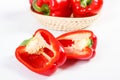 Fresh red peppers with wicker basket lying on white background, healthy nutrition concept Royalty Free Stock Photo