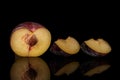 Fresh red plum isolated on black glass Royalty Free Stock Photo