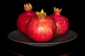 Fresh red pomergranate isolated on black glass Royalty Free Stock Photo